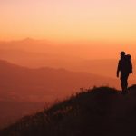Lucid_Origin_Silhouette_of_a_lone_traveler_walking_on_a_windin_0